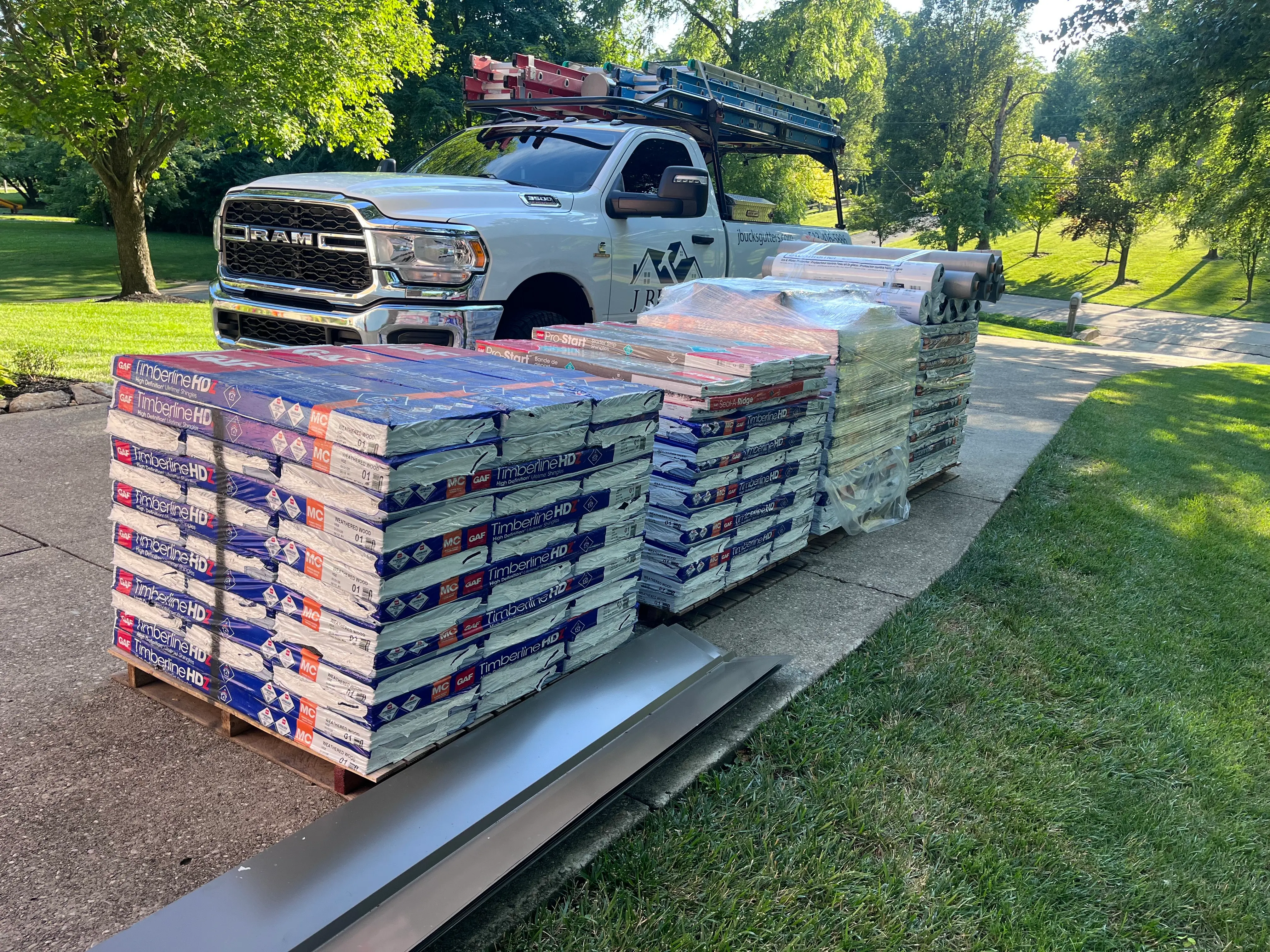 J Bucks Gutters branded work truck and premium GAF roofing materials